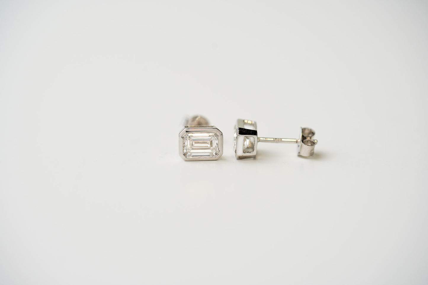 14k White Gold 2.05tcw Bezel Set Emerald Cut Diamond Stud Earrings