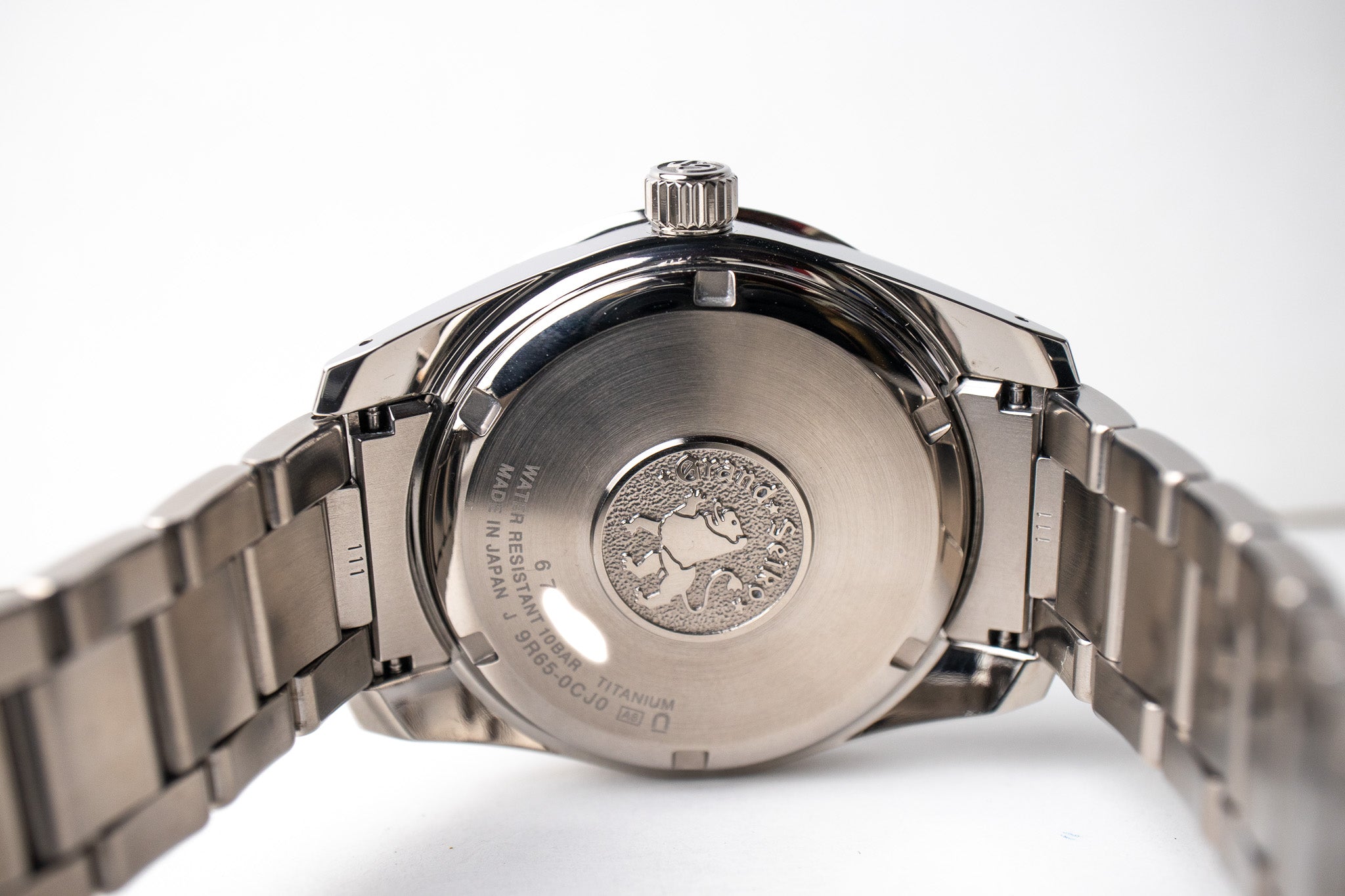 Grand Seiko SBGA147 titanium men's watch case back with Grand Seiko logo and lion